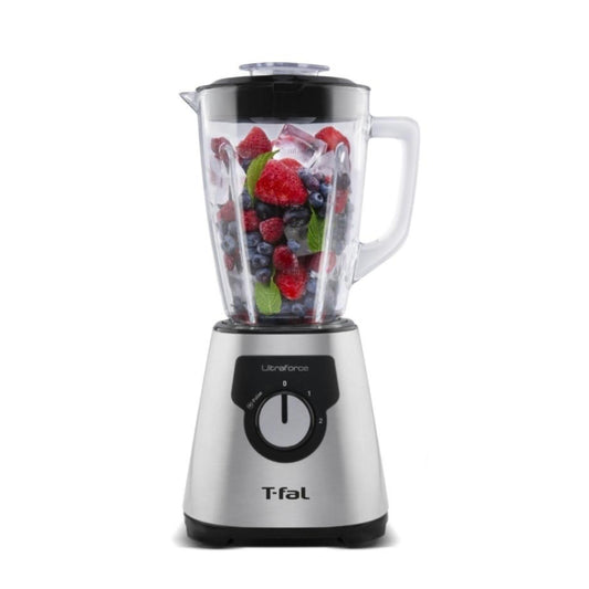 Licuadora T-Fal UltraForce con base de acero inoxidable y vaso de vidrio de 2.2L con frutas frescas dentro.